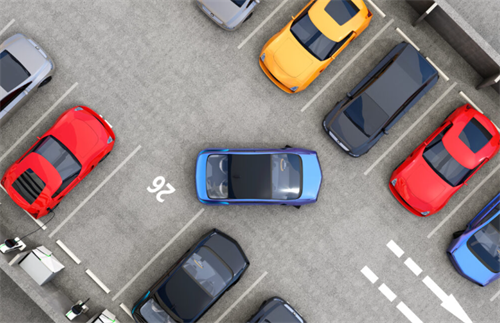 Aerial view of parked electric cars in a charging station, representing long-term parking scenarios where battery self-discharge matters.